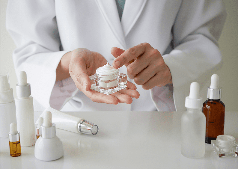 Laboratory worker with skincare items