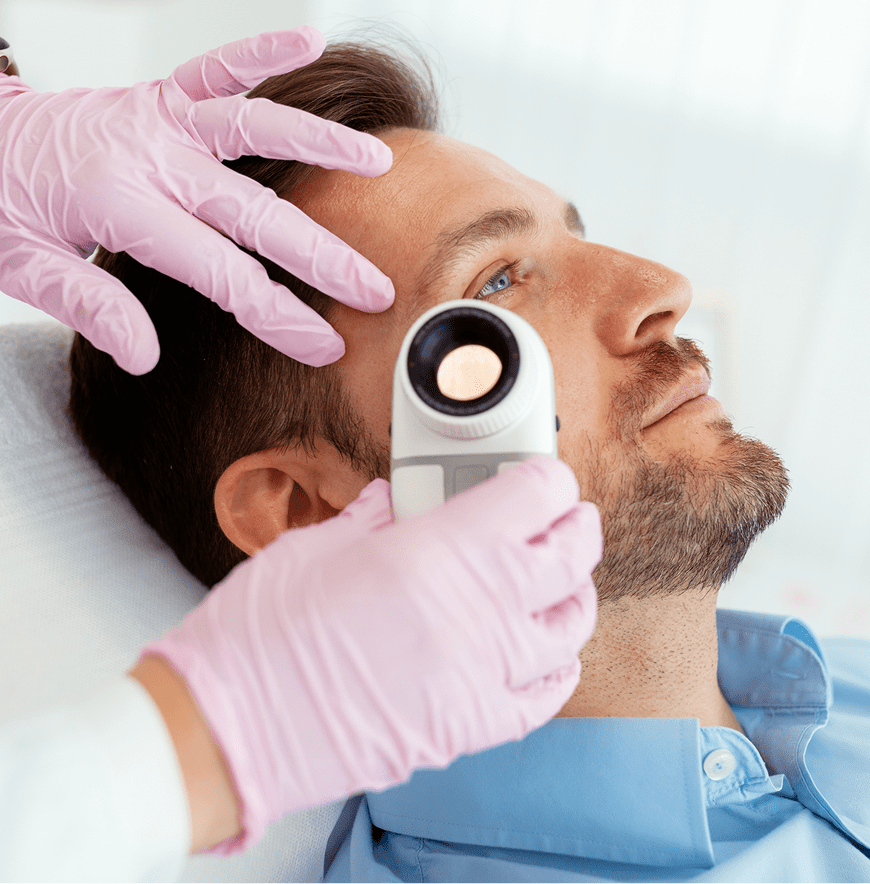 Dermatologist examining man's skin with dermatoscope