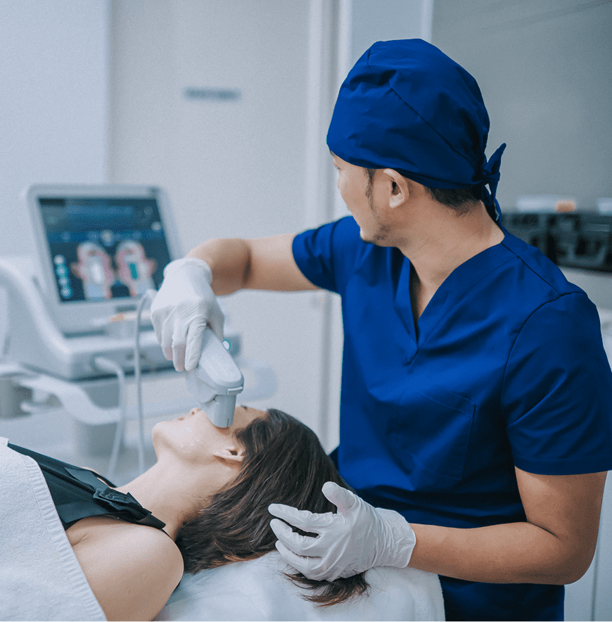 Doctor using ultrasound device on patient